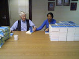 Lester signing copies Plan B 4.0 as gifts with help from Millicent.
